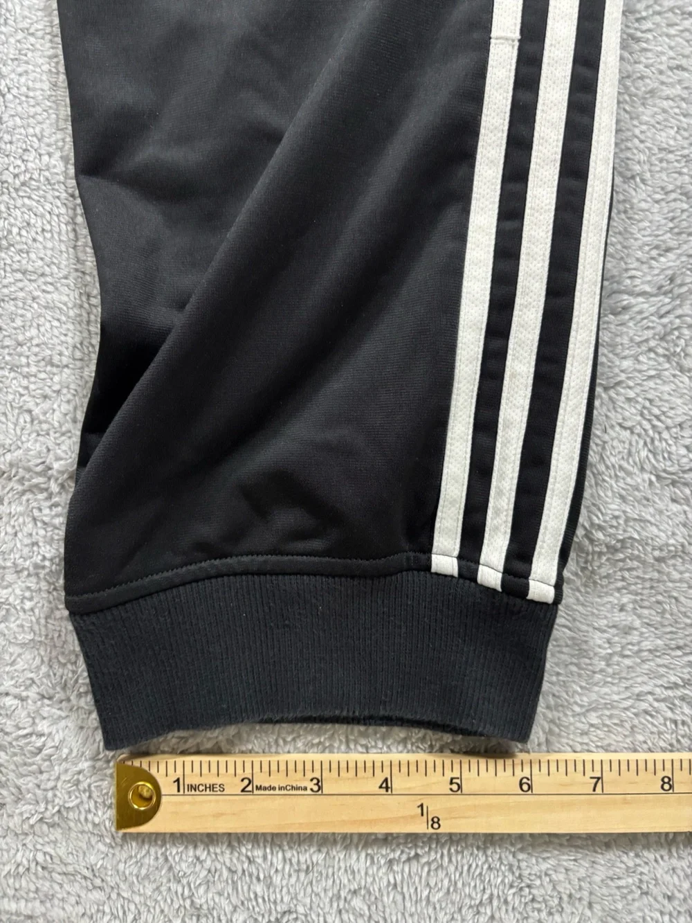 Adidas black track pants with white stripes